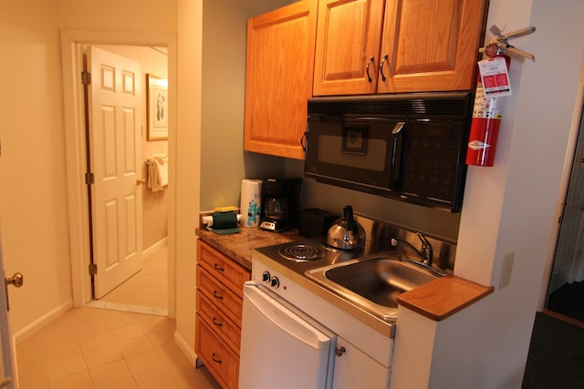 kitchen with light tile patterned floors and sink