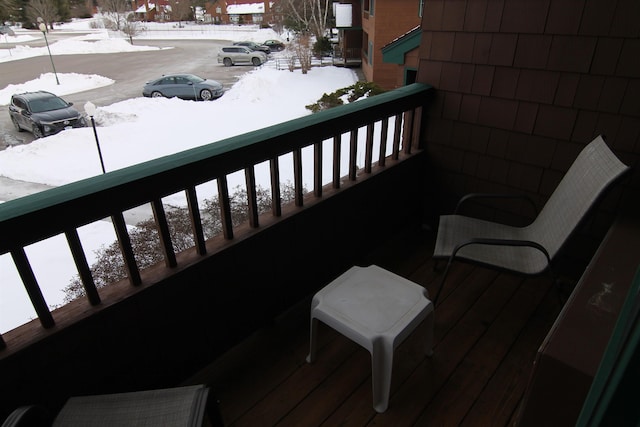 view of snow covered back of property