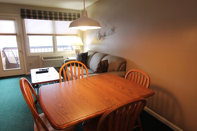 carpeted dining space with an AC wall unit