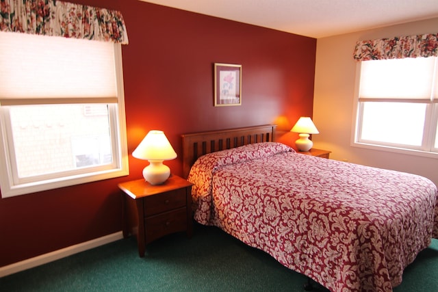 carpeted bedroom featuring multiple windows