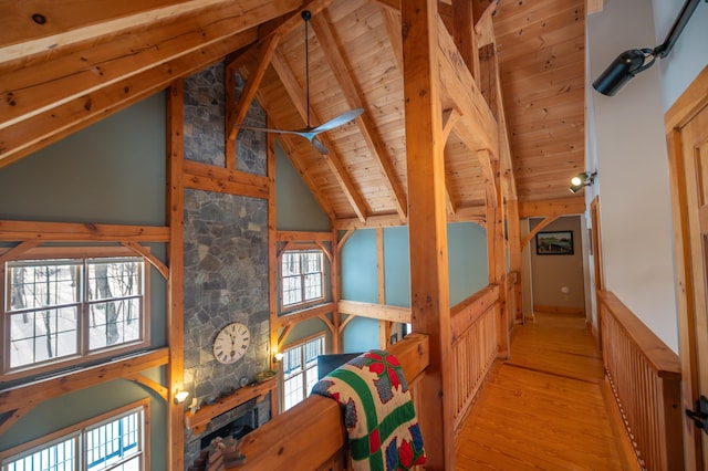 interior space with beam ceiling, high vaulted ceiling, wood ceiling, and light hardwood / wood-style floors