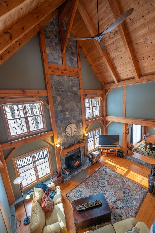 living room featuring high vaulted ceiling, wood ceiling, beamed ceiling, and hardwood / wood-style floors