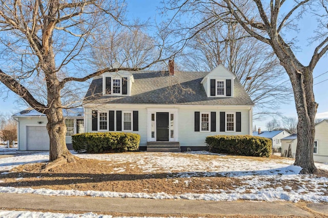 cape cod-style house featuring a garage