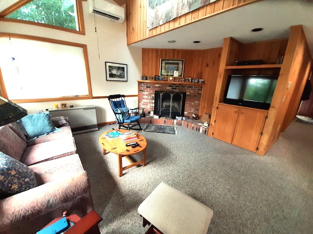 living room with a brick fireplace, an AC wall unit, and carpet floors