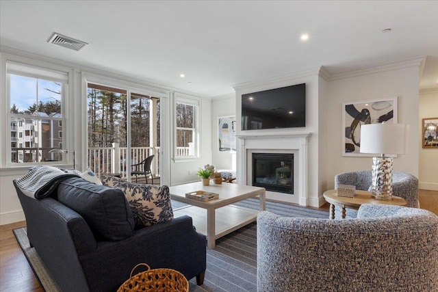 living room with hardwood / wood-style flooring and ornamental molding