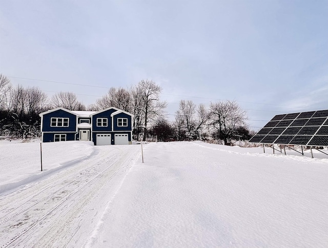 yard covered in snow featuring a garage