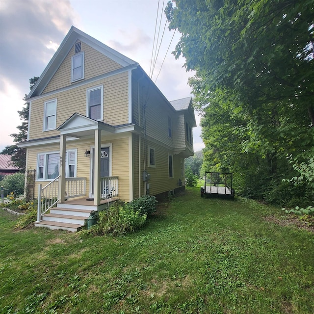 rear view of property with a lawn