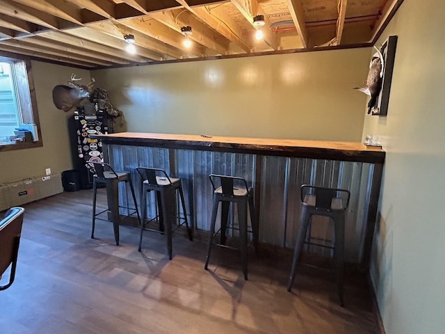 bar with wood-type flooring