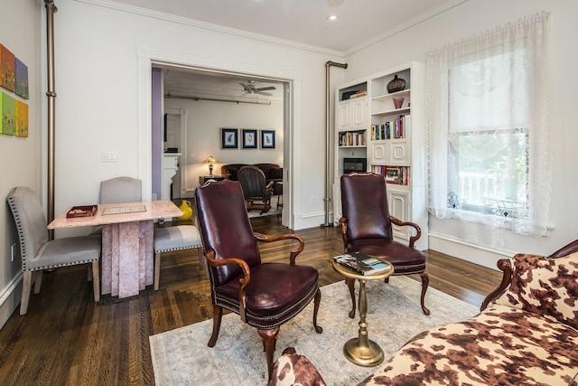 sitting room with dark hardwood / wood-style flooring and crown molding