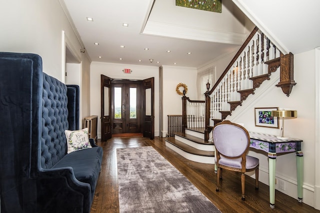 foyer with dark hardwood / wood-style floors and crown molding