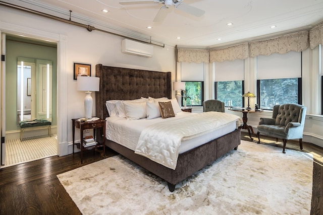 bedroom with a wall unit AC, ceiling fan, and hardwood / wood-style floors