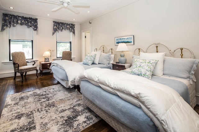 bedroom with ceiling fan, dark hardwood / wood-style floors, and ornamental molding