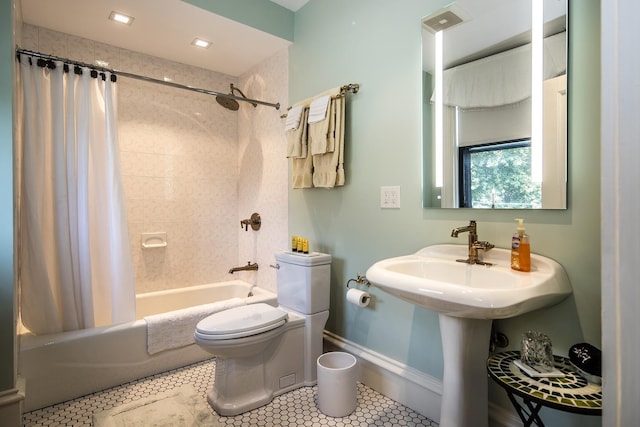 bathroom featuring shower / bath combo with shower curtain, tile patterned floors, and toilet