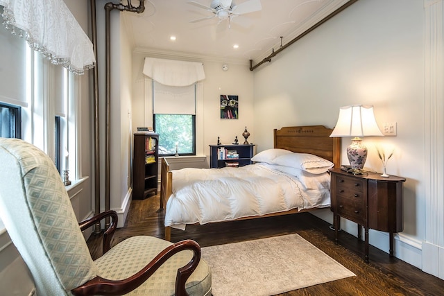 bedroom with ceiling fan, dark wood-type flooring, and ornamental molding