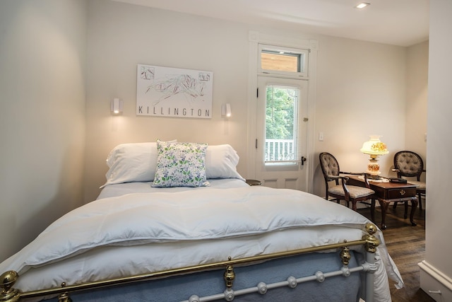 bedroom with dark hardwood / wood-style floors