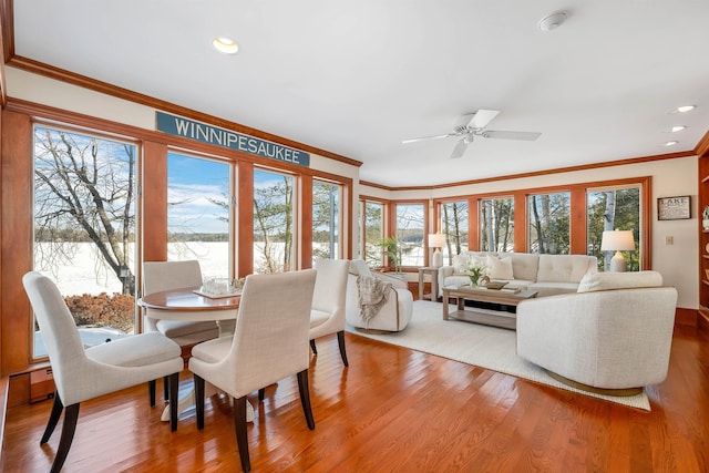 dining space with ceiling fan, ornamental molding, and hardwood / wood-style flooring