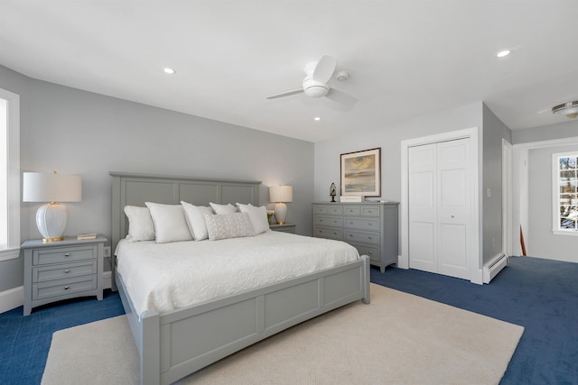 bedroom with ceiling fan, carpet, a closet, and baseboard heating