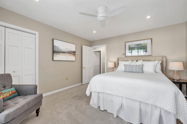 carpeted bedroom with ceiling fan and a closet