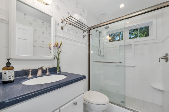 bathroom featuring toilet, an enclosed shower, and vanity