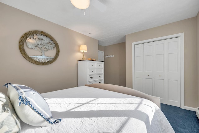 carpeted bedroom with ceiling fan and a closet