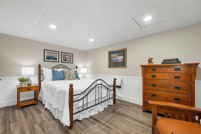 bedroom featuring dark wood-type flooring and a paneled ceiling