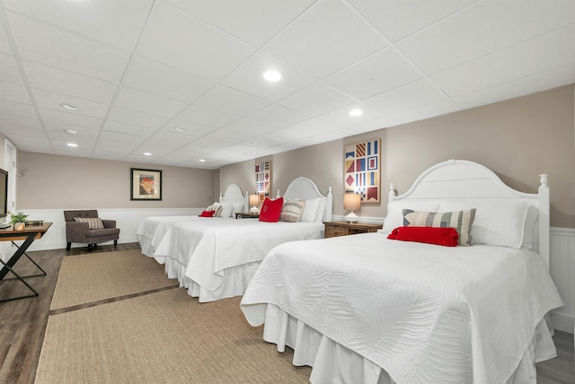 bedroom featuring a paneled ceiling and hardwood / wood-style flooring