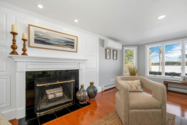 living room with a baseboard heating unit, hardwood / wood-style floors, a wall mounted AC, and a tiled fireplace