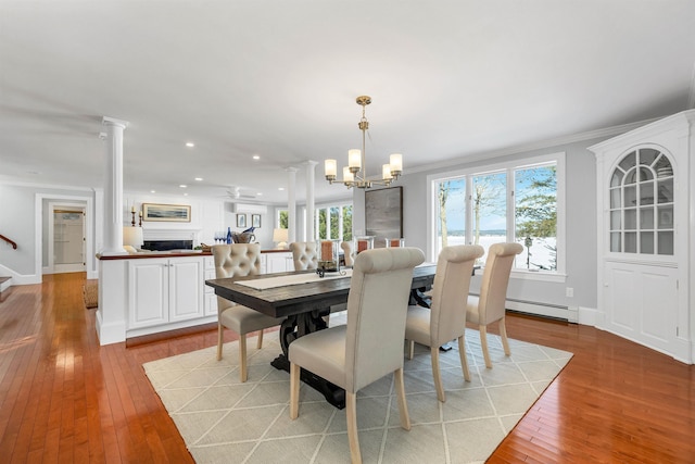 dining room featuring an inviting chandelier, ornamental molding, baseboard heating, and plenty of natural light