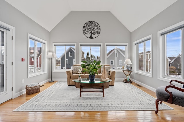 sunroom / solarium featuring plenty of natural light and vaulted ceiling