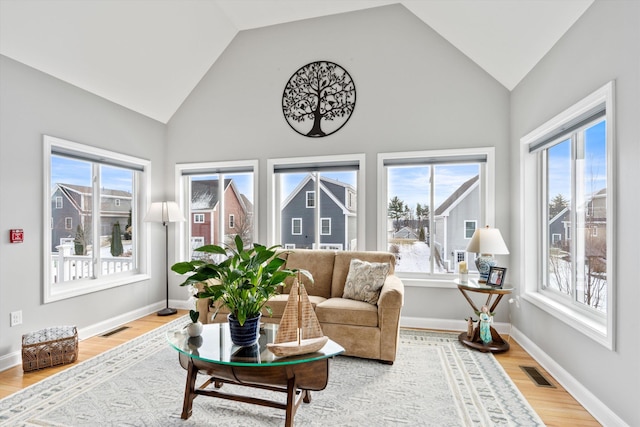 sunroom with plenty of natural light and vaulted ceiling