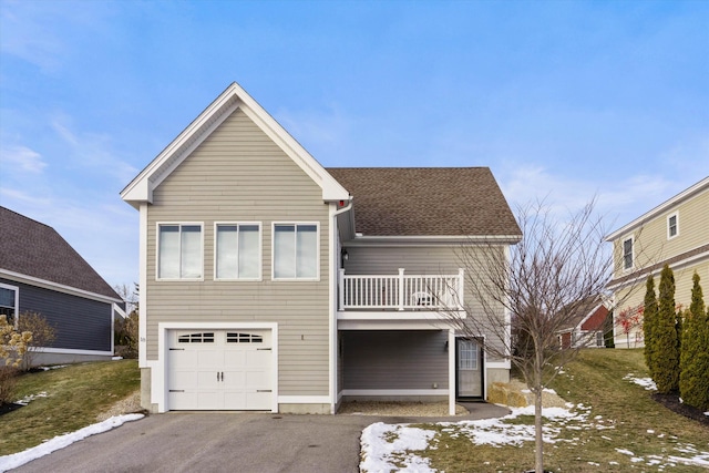 view of front of house featuring a balcony and a garage