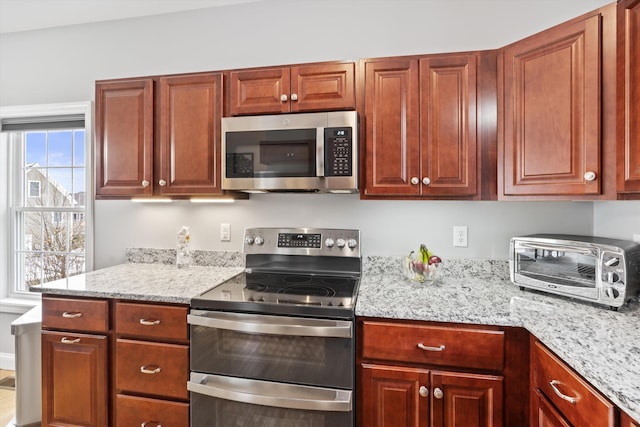 kitchen with light stone countertops and stainless steel appliances