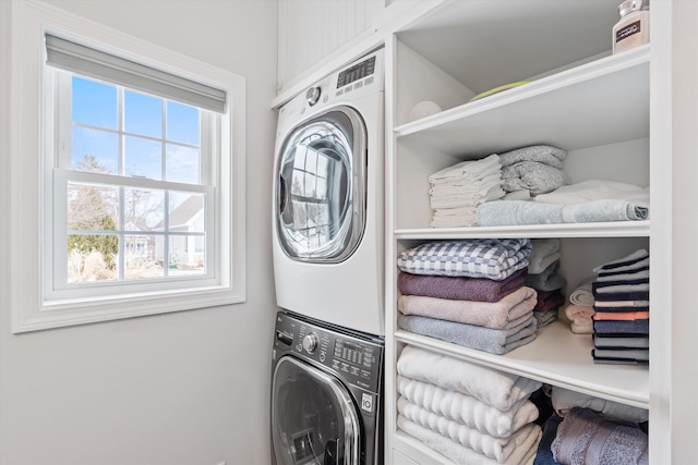 laundry room featuring stacked washer / dryer