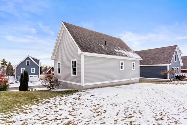 view of snow covered back of property