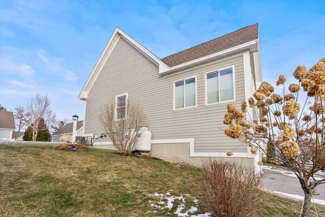 view of side of home featuring a yard