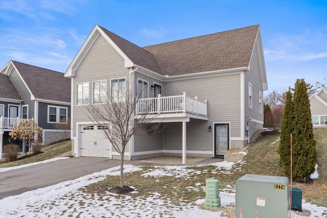 view of front of property with a garage and a balcony