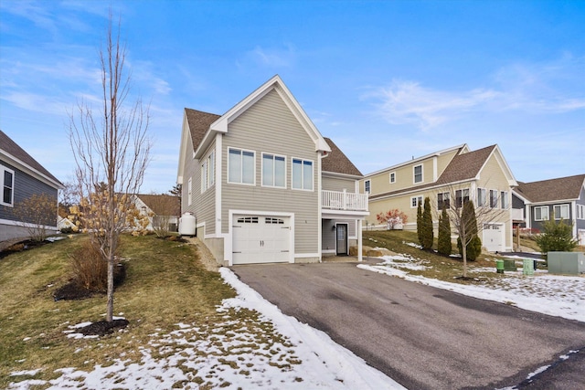 front of property with a balcony and a garage