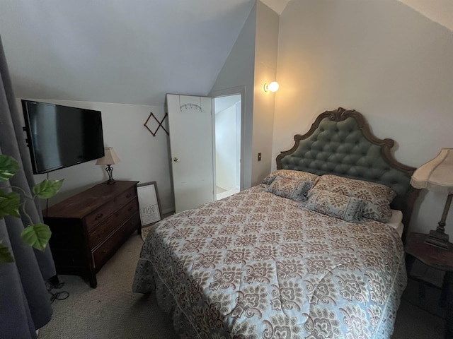 carpeted bedroom featuring lofted ceiling