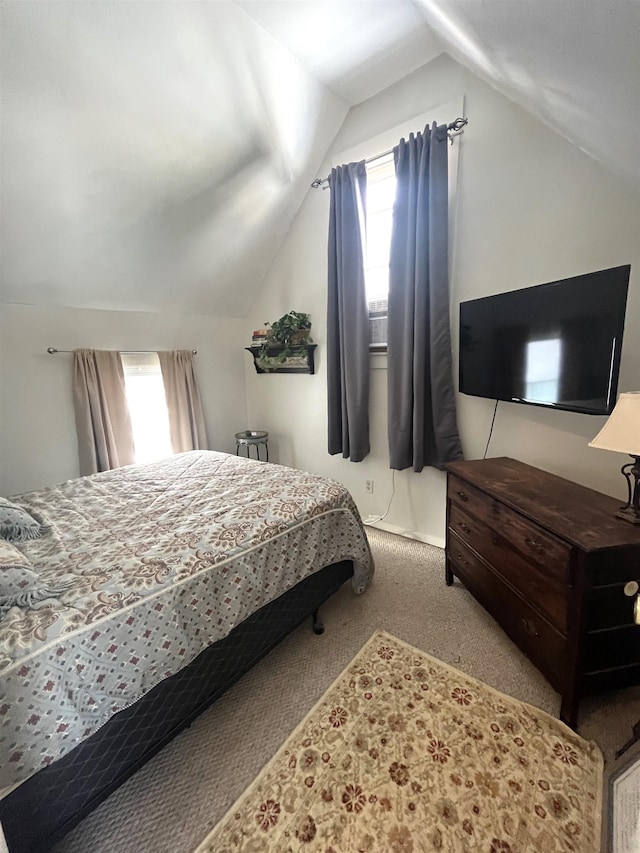 bedroom featuring lofted ceiling and carpet floors