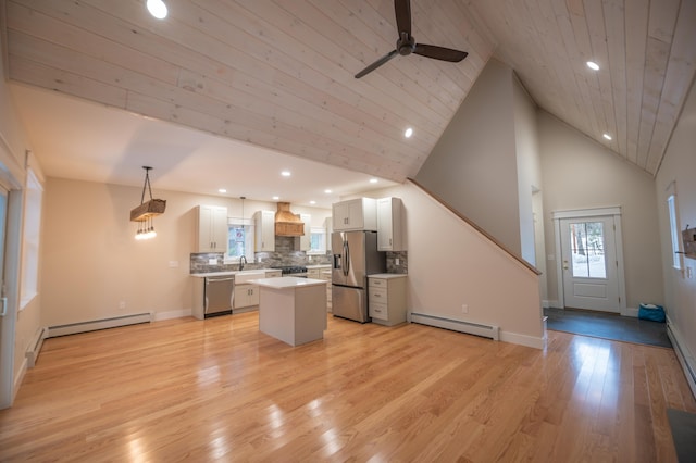 kitchen with a baseboard radiator, stainless steel appliances, a center island, and hanging light fixtures