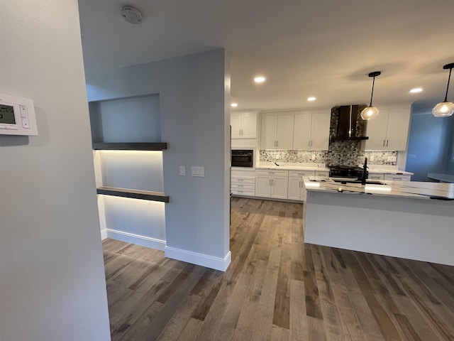 kitchen featuring hanging light fixtures, dark hardwood / wood-style flooring, sink, and white cabinetry