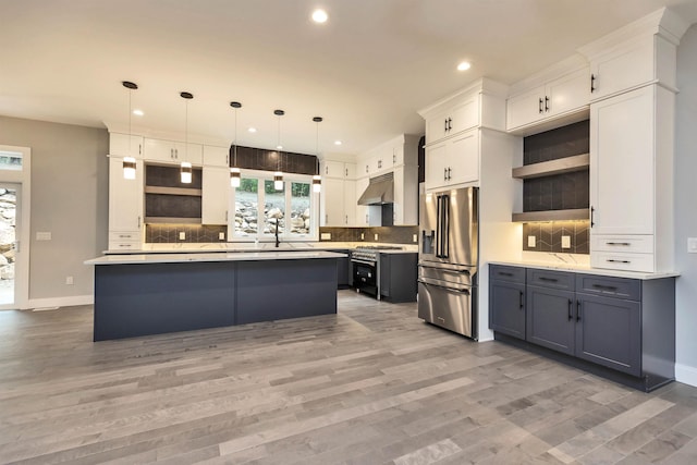 kitchen featuring backsplash, pendant lighting, white cabinets, and high quality appliances