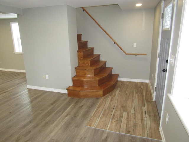 stairs with hardwood / wood-style floors