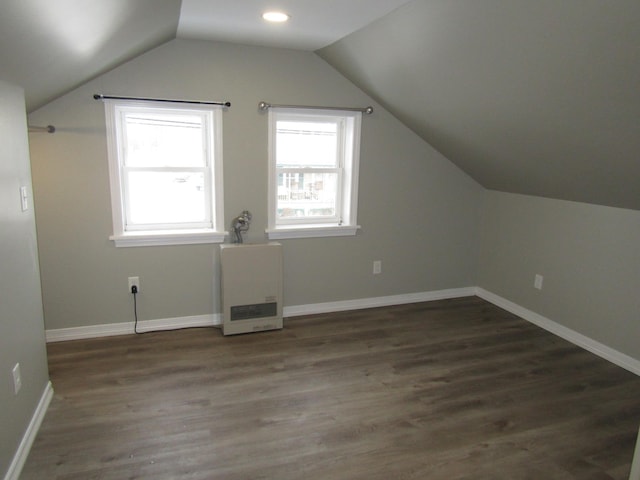 additional living space featuring dark hardwood / wood-style floors and lofted ceiling