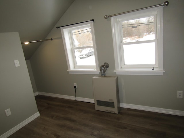 bonus room featuring dark wood-type flooring and lofted ceiling