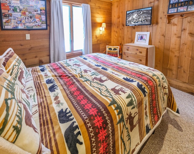 carpeted bedroom featuring wood walls