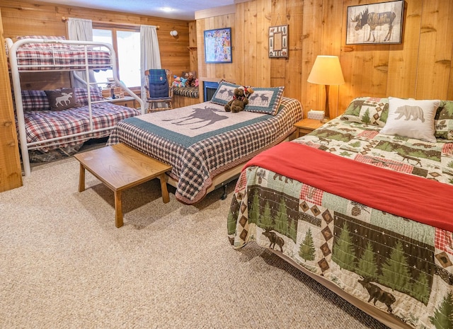 bedroom featuring wood walls and carpet flooring