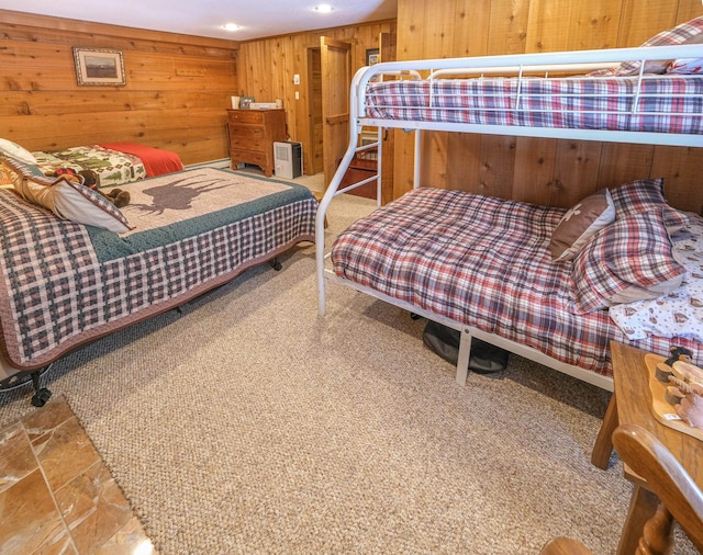 bedroom featuring wooden walls