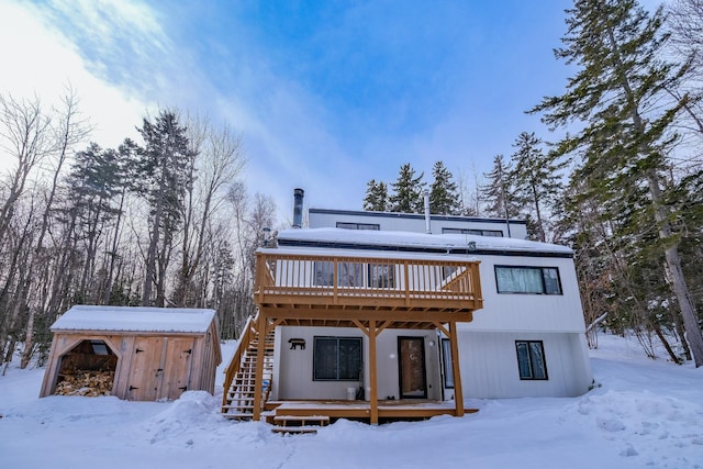 view of front of house featuring a deck and a shed