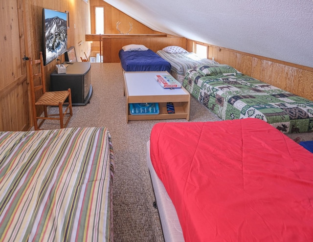 bedroom with lofted ceiling, wood walls, a textured ceiling, and carpet flooring